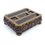 A Victorian inkstand / Standish of carved oak with pen rest sections,