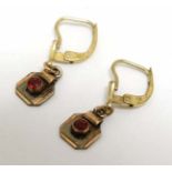 A pair of gilt metal earrings set with red stones CONDITION: Please Note - we do