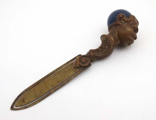 A late 19thC / early 20thC brass book mark / page mark surmounted by the head of a negro male with