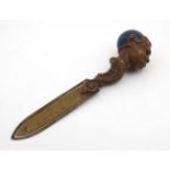 A late 19thC / early 20thC brass book mark / page mark surmounted by the head of a negro male with