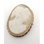 A cameo brooch set with classic oval cameo within a yellow metal mount.