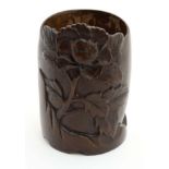 An Oriental carved bamboo pot with flowering peony decoration.