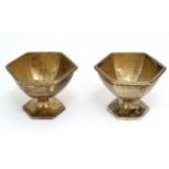 A pair of silver gilt salts of hexagonal pedestal form.