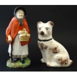 A Victorian Staffordshire figure depicting an elderly female wearing red cloak,