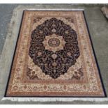 Carpet / Rug: A machine made Persian Keshan style carpet with midnight blue / black central