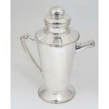 A 21stC Art Deco style cocktail shaker with menu / recipe dial and pouring spout 11 1/2" high