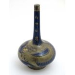 A Chinese bottle vase decorated in gilt with 5 clawed dragon on a powder blue ground,