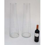 Lilly vases : A pair of tapering cylindrical glass lilly vases.