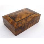 A 20thC burrwood cigarette box with ebony inlay 7 1/2" wide x 2 1/2" high x 4 5/8" deep