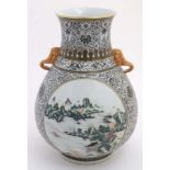 A large Chinese globular vase having twin handles formed as elephant heads,