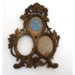 A black forest triple miniature easel / strut photograph frame having the Furniture makers label