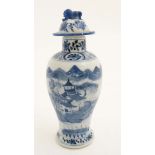 A Chinese blue and white baluster vase and cover, the body decorated with buildings ,