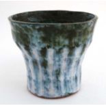 A Studio Pottery Planter / Jardiniere decorated in shades of blue and green on a white ground bears