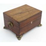 A 19thC mahogany fitted box with pressed brass handles and feet and opening to reveal fitted