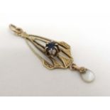 A gilt metal pendant set with central blue stone and mother of pearl drop . approx.