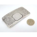 A hip formed card case with engraved decoration.