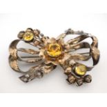 American Vintage Costume Jewelery by Hobé : A silver and gold plated brooch of stylised bow and