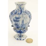 A small blue and white Delft style vase,