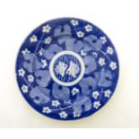 A small Chinese blue and white ceramic plate. Decorated with floral and foliate images.