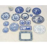 A collection of blue and white plates, a jug, meat plates and a butter dish and cover ,