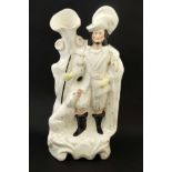 A 19thC Staffordshire spill vase figure of a hunter standing on an arched scrolled gilt lined base