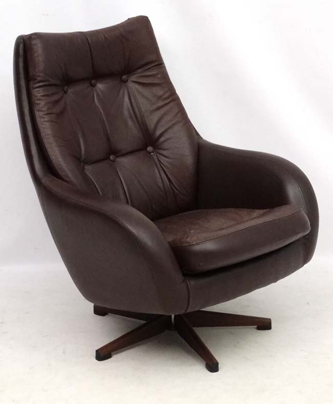 Vintage Retro : a Swedish Swedfurn brown leather swivel button back armchair with five spoke base,