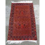 Carpet / Rug :A handmade woollen rug with two vignettes of prancing horses,