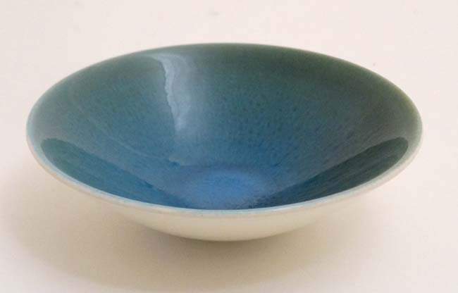 A small Poole pottery bowl in a blue moon style , bears factory stamp to base. 5 1/4'' high.