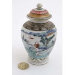 A small Chinese famille rose baluster lidded vase , decorated with figures and goats,