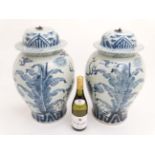 A large pair of Chinese blue and white jars and covers,