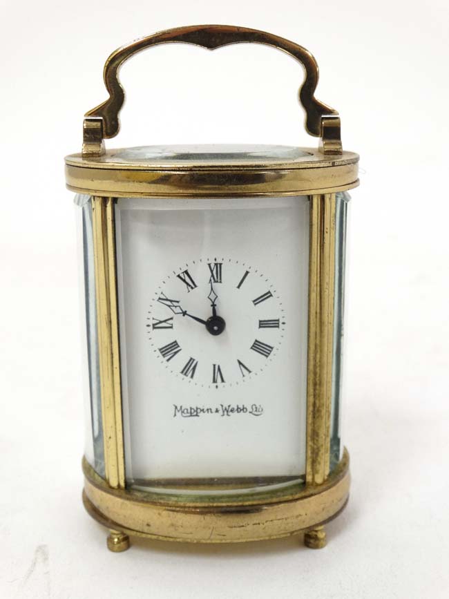 Oval Miniature Mappin & Webb Ltd Carriage Clock : a 4 shaped and bevelled glass with oval bevelled