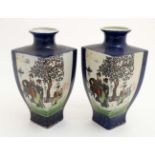 A pair of Oriental vases of square shape decorated in panels with figures in a landscape on a