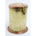 Arts and crafts A brass and copper cylindrical hinged lidded tea caddy.