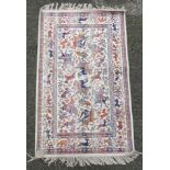 Carpet / rug : a silk small rug with images of figures on horseback, antelope,