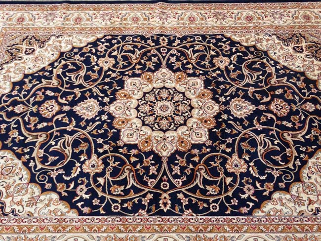 Carpet / Rug: A machine made Persian Keshan style carpet with midnight blue / black central - Image 5 of 7