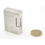 A French white metal cigarette lighter by S J Dubont. Paris.