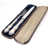 A Victorian silver and close plate carving set comprising knife and fork within a Moroccan leather