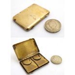 A C.1900 brass book formed hinged stamp case opening to reveal four stamp sections within.