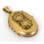 A gilt metal locket of oval form approx.