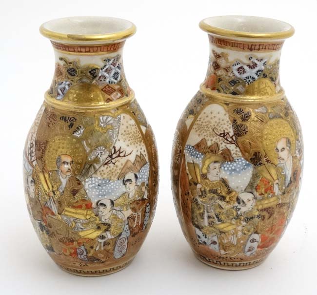 A pair of Japanese Satsuma vases, decorated with figures and mountainous landscape,