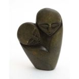 An abstract carved African soapstone figure depicting mother a child.