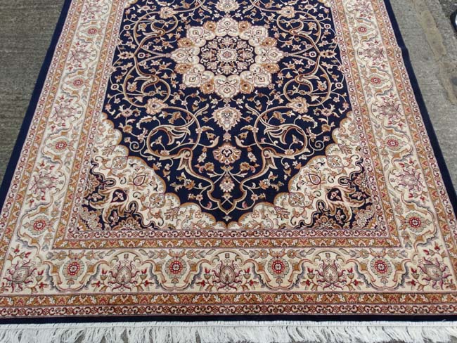 Carpet / Rug: A machine made Persian Keshan style carpet with midnight blue / black central - Image 2 of 7