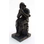 A cast bronze figure upon marble base depicting a seated fisherman lighting a pipe 6" high