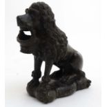 A 19thC carved Green marble / serpentine figure of a seated poodle dog holding a basket in mouth.