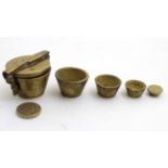 A set of Victorian brass cup weights comprising 5 various weights,