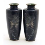 A pair of Japanese cylindrical enamelled vases with wisteria like cloisonne decoration.