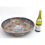 A Large Chinese bowl decorated in Imari style colours on a white ground,