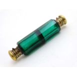 A Victorian green glass double ended brass scent bottle 4 1/4" long CONDITION: