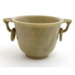 An Oriental grey green jade cup with captive ring handles 2" high x 2 1/2" wide