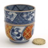 A miniature Japanese tea cup decorated in Imari colours, bears impressed mark to base. 2 1/4'' high.